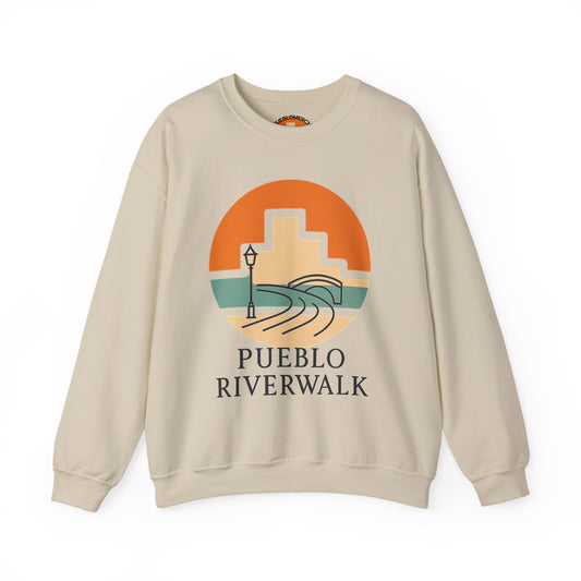 Sand color crewneck sweatshirt with Pueblo Riverwalk sunrise graphic design on front, displayed on white background.